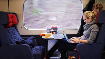 bringing-entertainment-long-ride-cropped-shot-attractive-young-woman-traveling-by-train