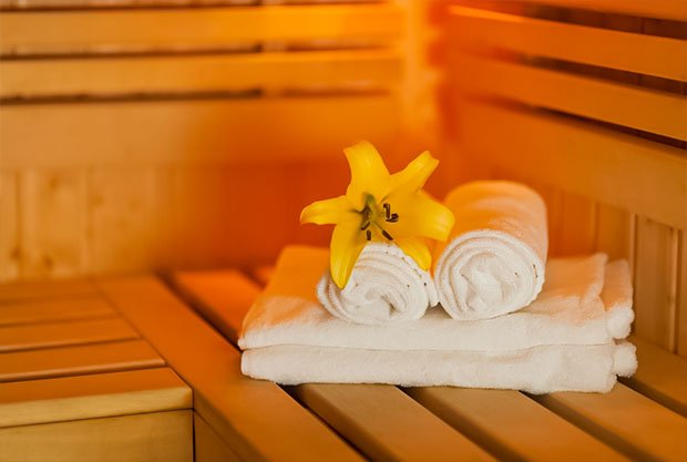 close-up-fresh-towels-yellow-lily-sauna
