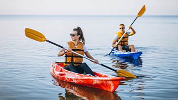 couple-together-kayaking-river