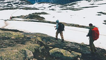 people-walk-across-mountains-covered-with-snow
