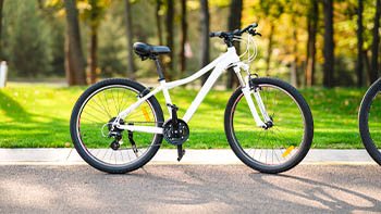 white-bicycle-standing-park